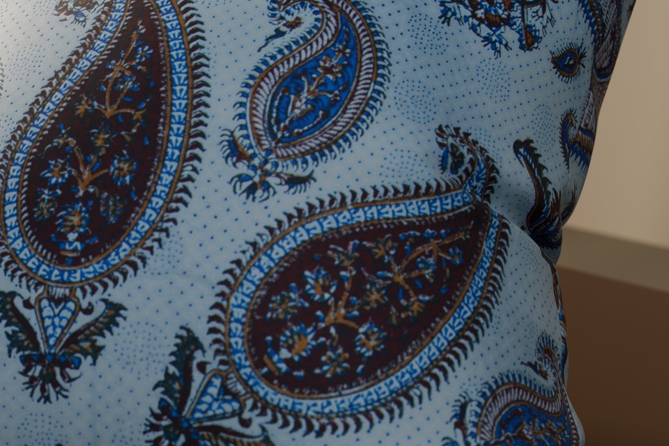 The qalamkar photo made into a Print material in Matelume, mapped once on a cushion at 800 mm source width and rendered in Blender Cycles under grazing light